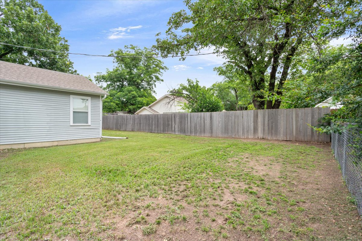 1607 North Harding Avenue Cameron, TX 76520 - Photo 37 of 37 A verdant lawn provides a spacious canvas for outdoor enjoyment, enclosed by privacy fencing.