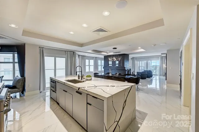 a kitchen with a stove a refrigerator and a dining table