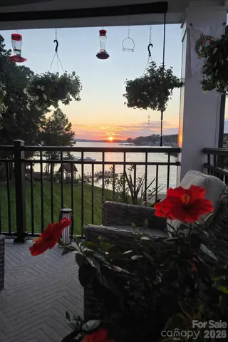 a front view of a house with swimming pool garden and trees