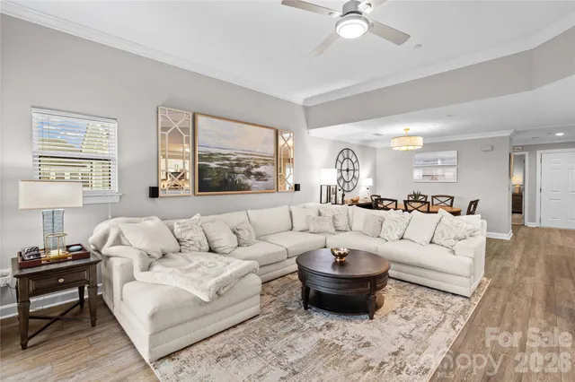 a front view of a building with garden and trees