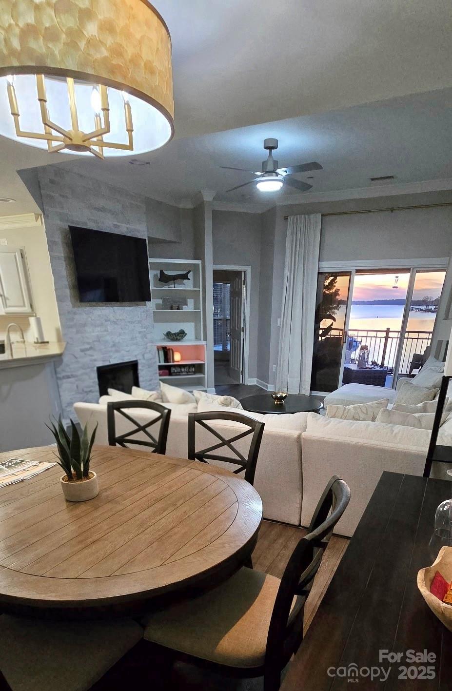 17810 Half Moon Lane, Unit L Cornelius, NC 28031 - Photo 12 of 48 a dining room with furniture and a flat screen tv
