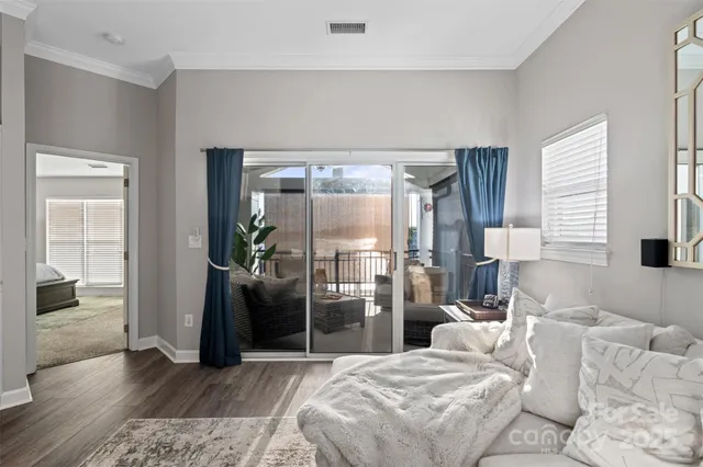 a bedroom with a bed and a large window