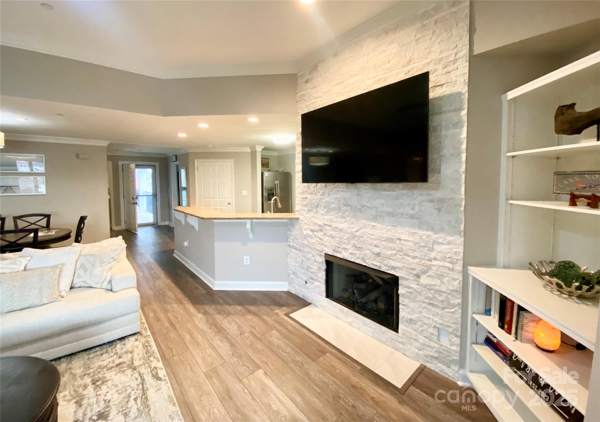 17810 Half Moon Lane, Unit L Cornelius, NC 28031 - Photo 14 of 48 a living room with fireplace furniture and a flat screen tv