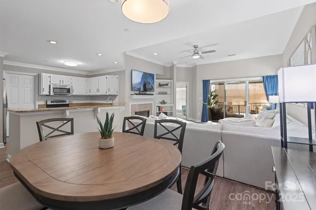 a dining room with furniture and a kitchen view