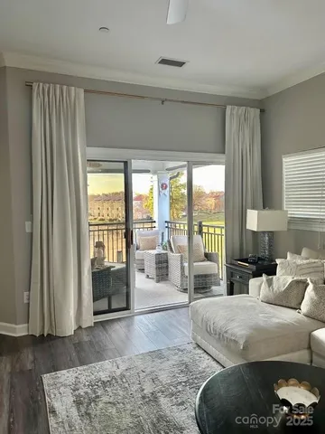 a living room with furniture and a floor to ceiling window