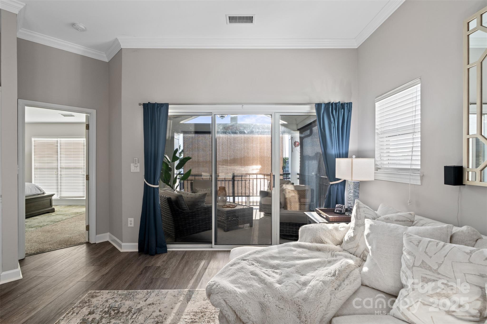 17810 Half Moon Lane, Unit L Cornelius, NC 28031 - Photo 18 of 48 a bedroom with a bed and a large window