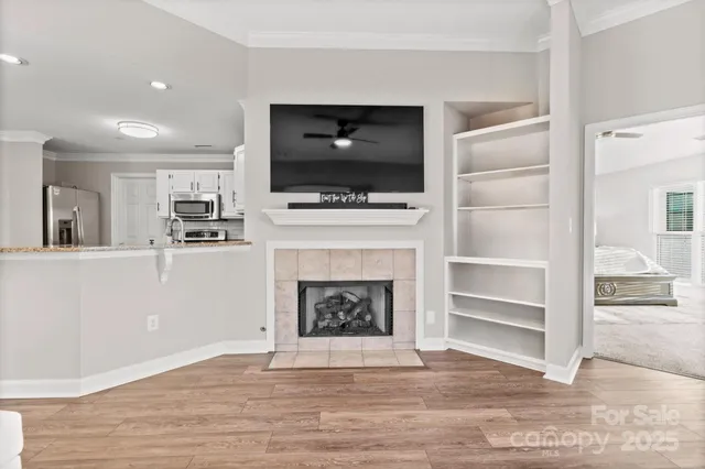 a living room with a fireplace and a flat screen tv