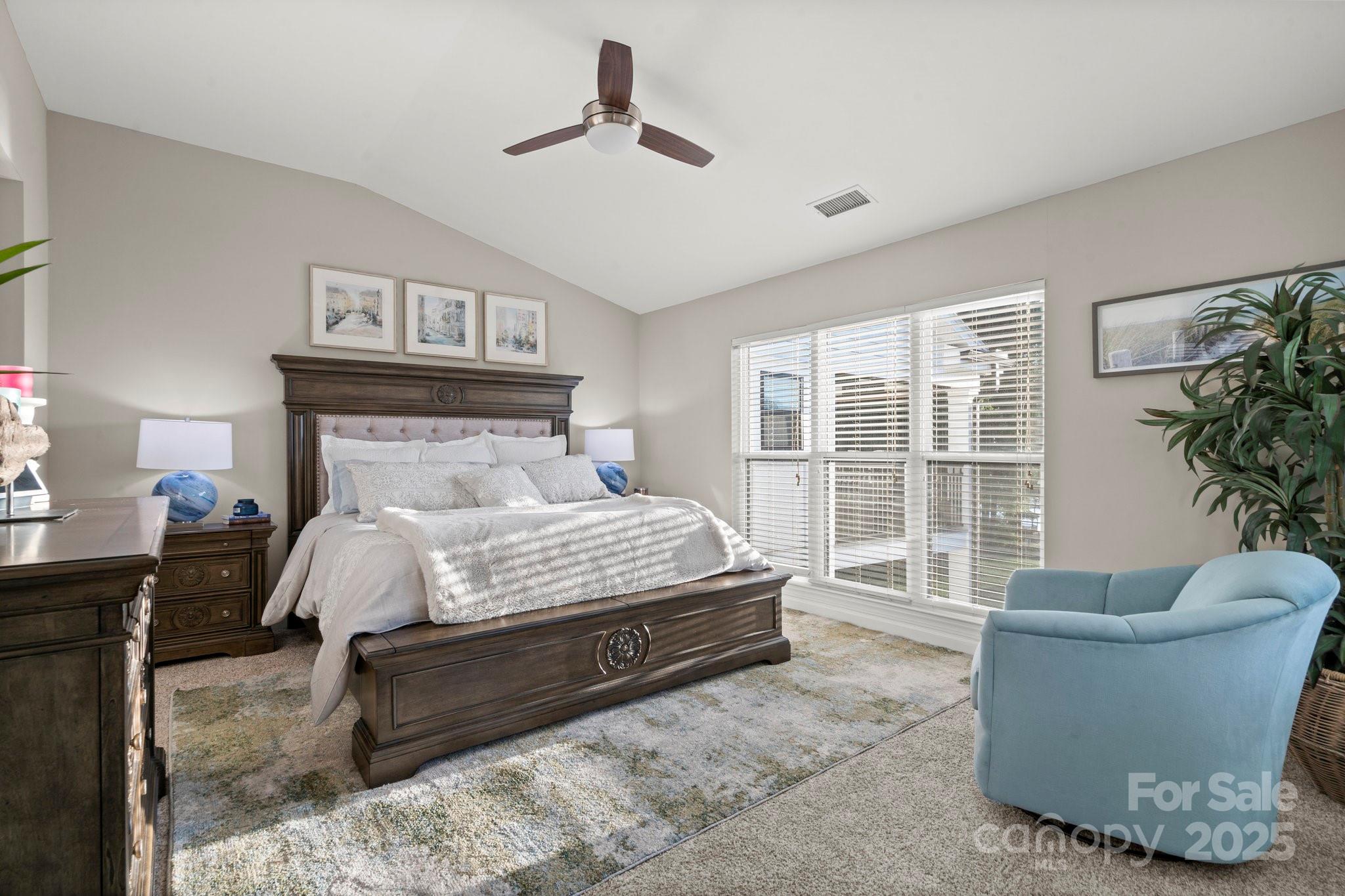 17810 Half Moon Lane, Unit L Cornelius, NC 28031 - Photo 20 of 48 a bedroom with a large bed and a potted plant