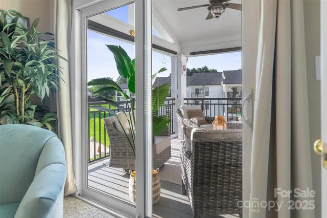 a living room with furniture and a floor to ceiling window
