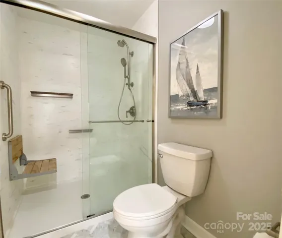 a bathroom with a shower a toilet and sink