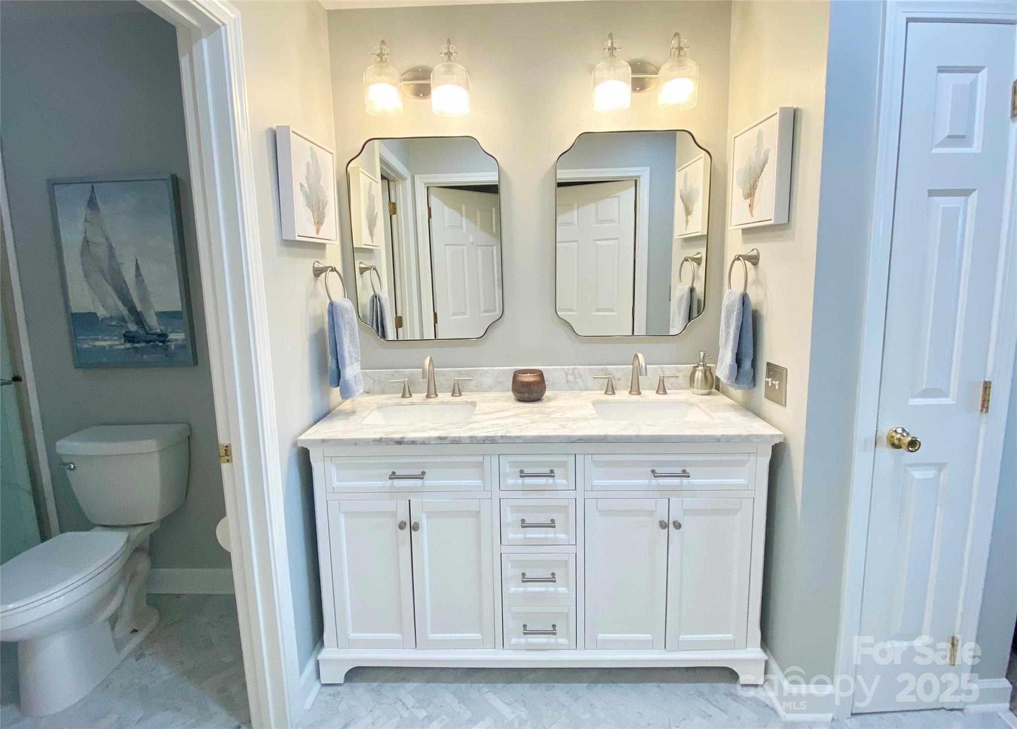 17810 Half Moon Lane, Unit L Cornelius, NC 28031 - Photo 25 of 48 a bathroom with double vanity sink a toilet and a mirror