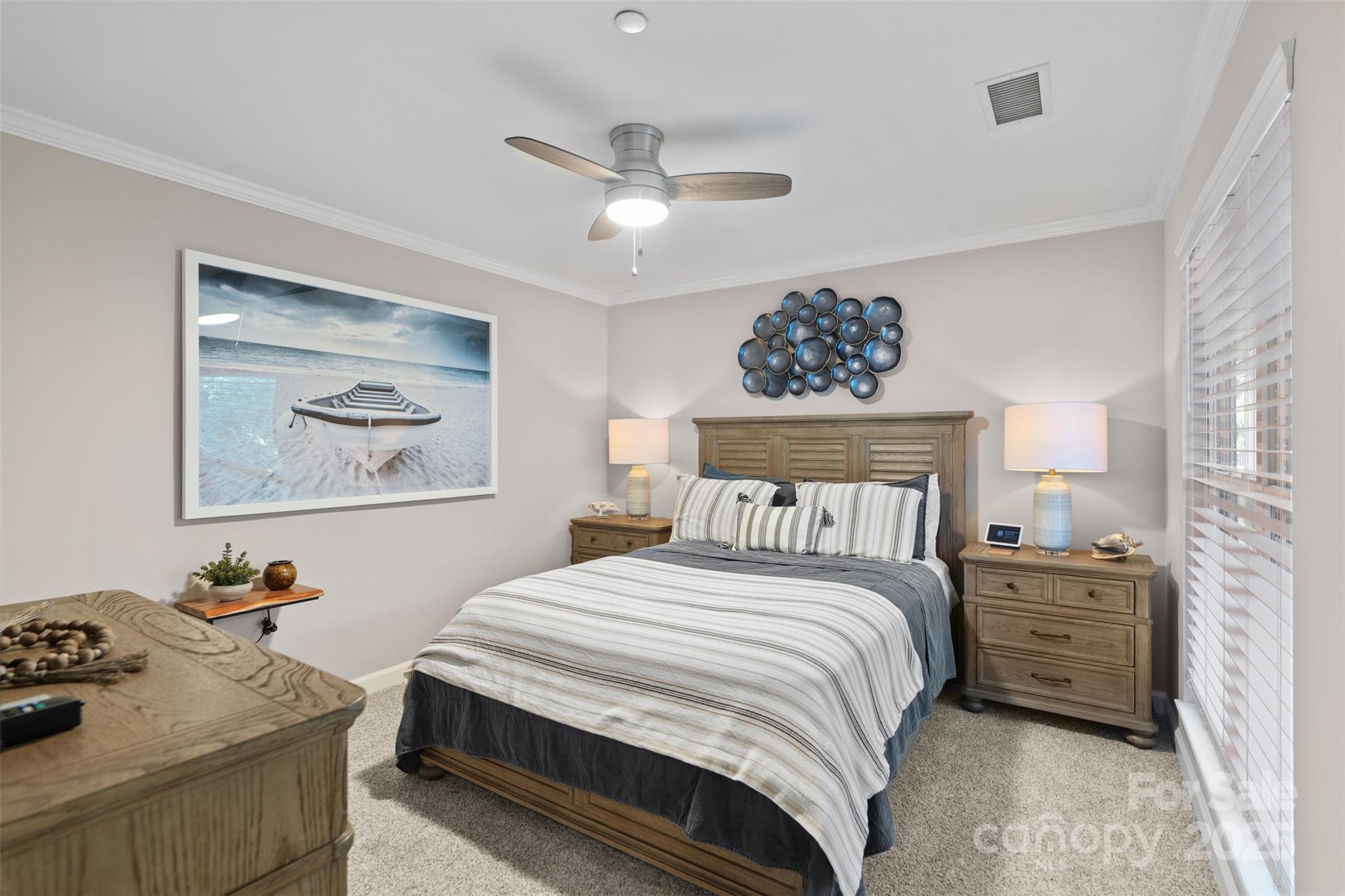 17810 Half Moon Lane, Unit L Cornelius, NC 28031 - Photo 27 of 48 a bedroom with a bed and a chandelier