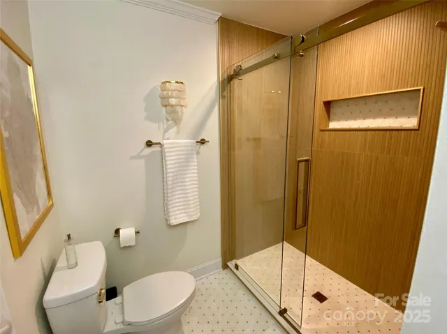 an aerial view of a house with a yard and lake view