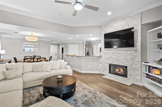 a living room with furniture a window and a clock