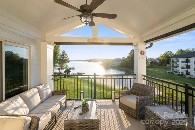 a balcony view with a couch and wooden floor