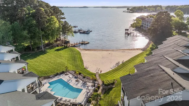 an aerial view of a house with a yard and lake view