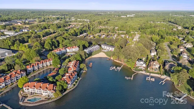 an aerial view of a house with a yard wooden table and chairs
