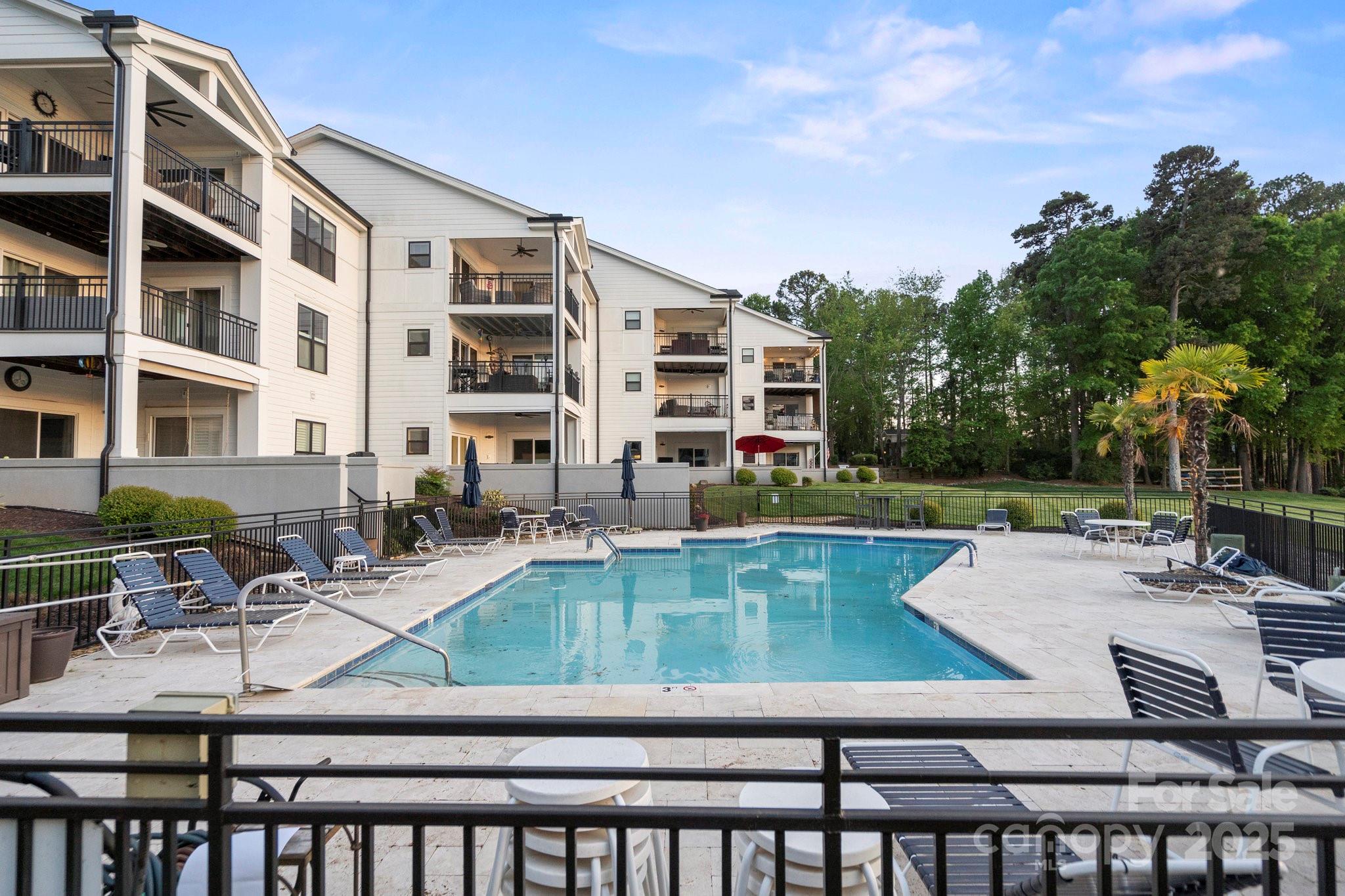 17810 Half Moon Lane, Unit L Cornelius, NC 28031 - Photo 36 of 48 a view of swimming pool with outdoor seating and plants