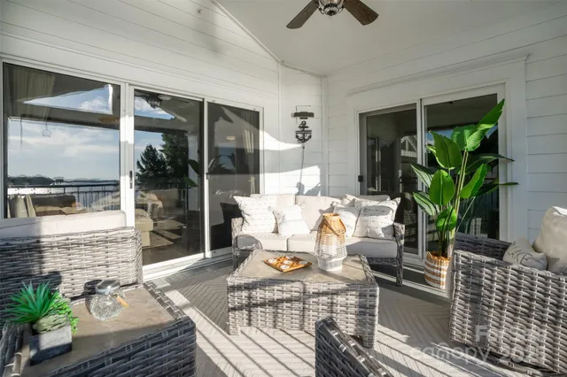 a view of living room with patio furniture and potted plants