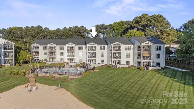 a front view of a house with swimming pool garden and trees