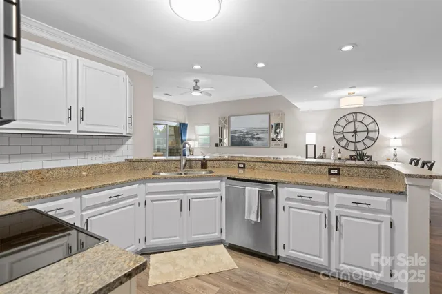 a kitchen with sink stove and cabinets