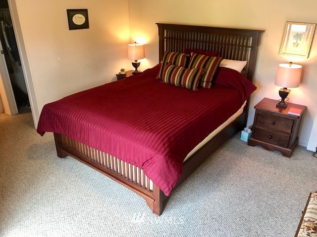 18937 Guava Street Southwest Rochester, WA 98579 - Photo 14 of 25 a bedroom with a bed and a lamp