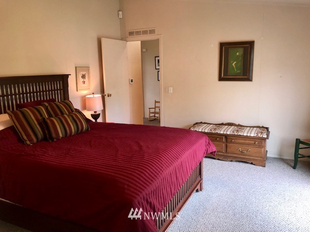 18937 Guava Street Southwest Rochester, WA 98579 - Photo 17 of 25 a bedroom with a bed and a painting on the wall