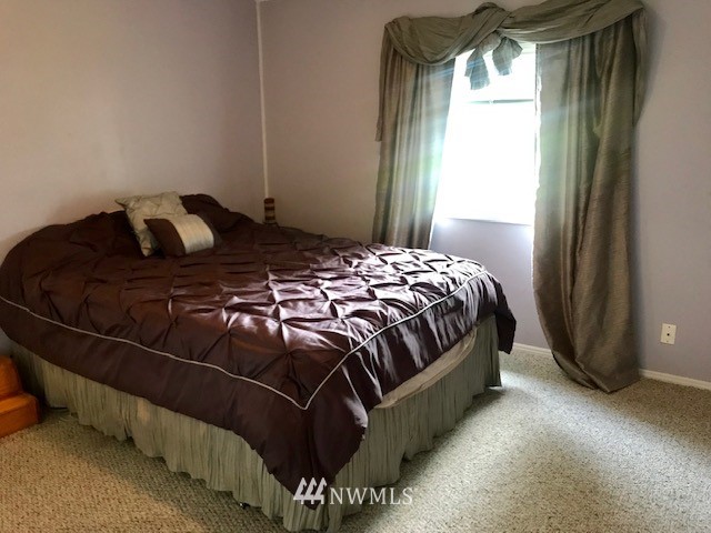 18937 Guava Street Southwest Rochester, WA 98579 - Photo 20 of 25 a bedroom with a bed and window