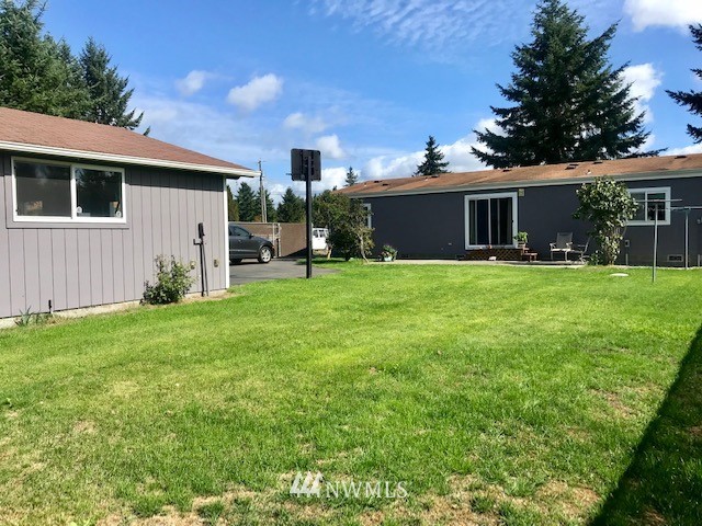 18937 Guava Street Southwest Rochester, WA 98579 - Photo 21 of 25 a backyard of a house with table and chairs