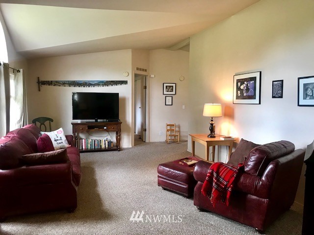 18937 Guava Street Southwest Rochester, WA 98579 - Photo 10 of 25 a living room with furniture and a flat screen tv