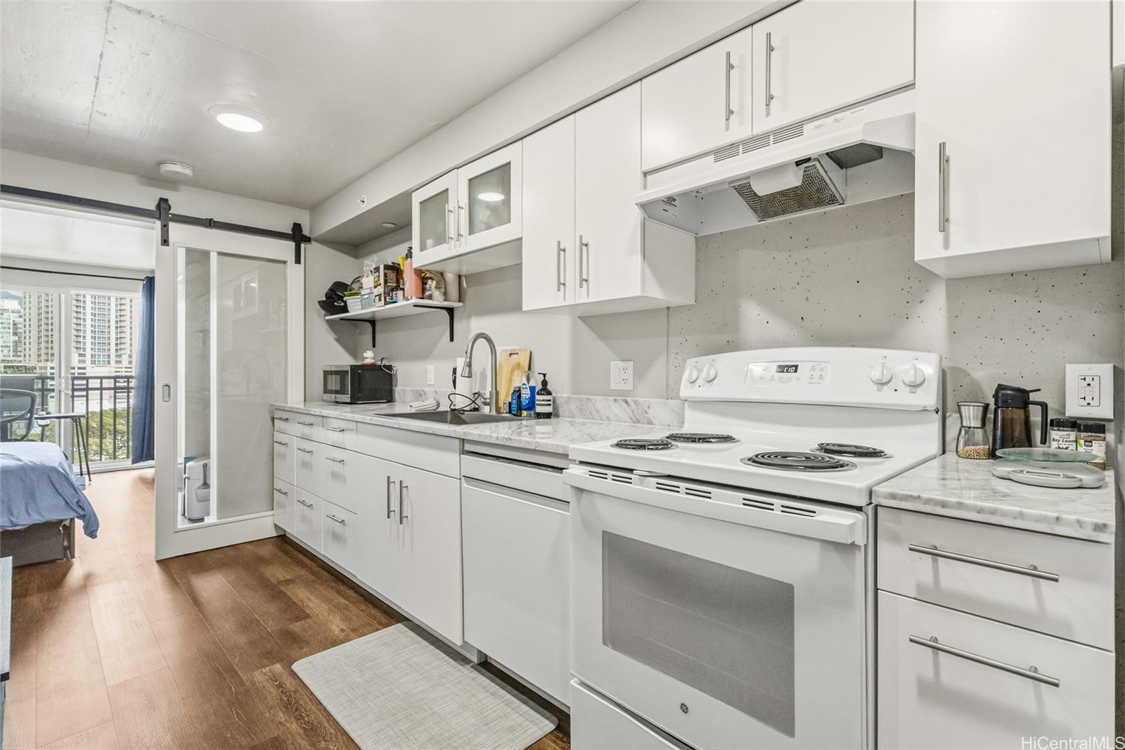 a kitchen with stainless steel appliances granite countertop a stove and white cabinets
