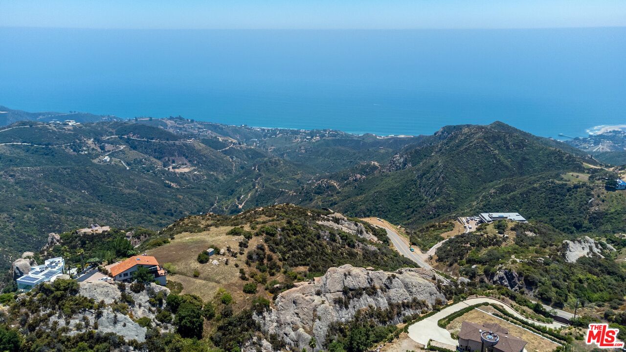 1 Piuma Road Malibu, CA 90265 - Photo 3 of 22 an aerial view of house with yard and mountain view in back