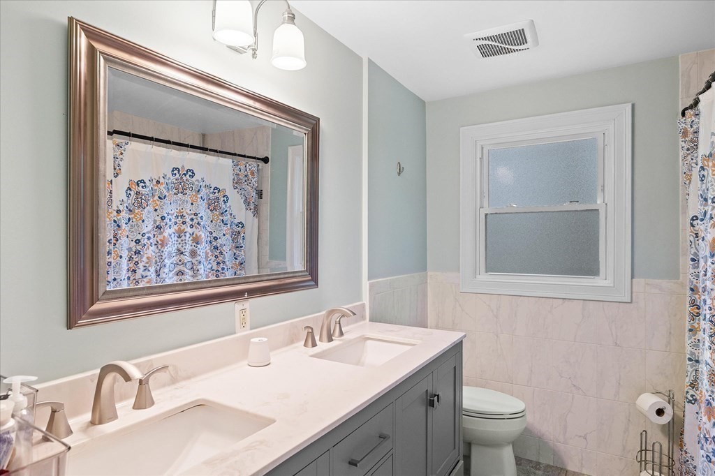6 Nancy Drive Auburn, MA 01501 - Photo 13 of 27 a bathroom with a granite countertop sink a toilet and a mirror