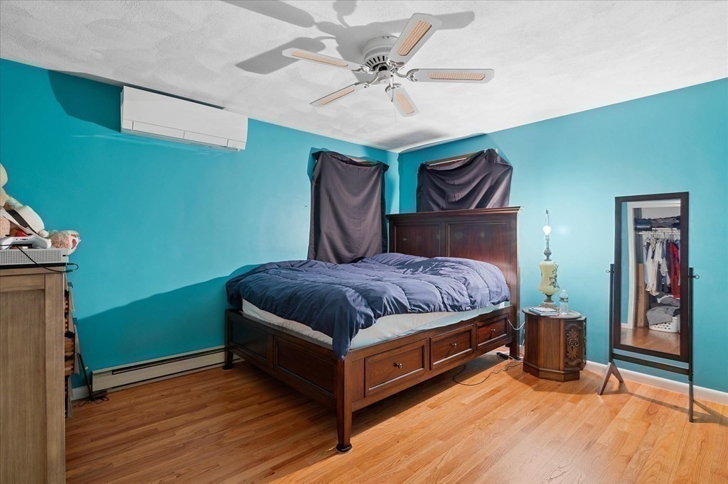 6 Nancy Drive Auburn, MA 01501 - Photo 14 of 27 a spacious bedroom with a bed and a chandelier