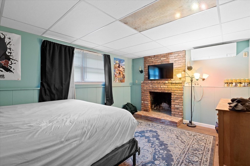 6 Nancy Drive Auburn, MA 01501 - Photo 22 of 27 a bedroom with a bed and a fireplace