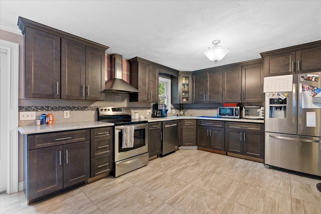 6 Nancy Drive Auburn, MA 01501 - Photo 6 of 27 a kitchen with granite countertop stainless steel appliances and wooden cabinets