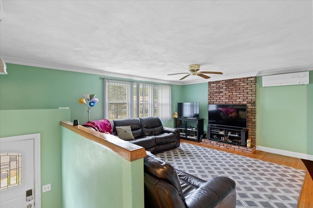 6 Nancy Drive Auburn, MA 01501 - Photo 9 of 27 a living room with furniture a flat screen tv and a window