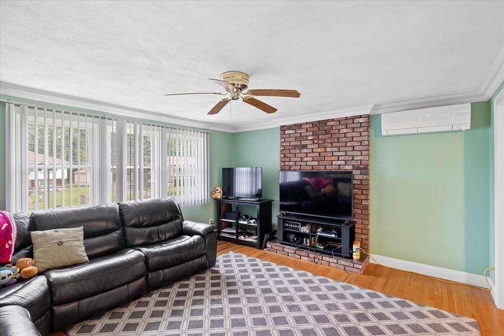 6 Nancy Drive Auburn, MA 01501 - Photo 10 of 27 a living room with furniture a flat screen tv and a window