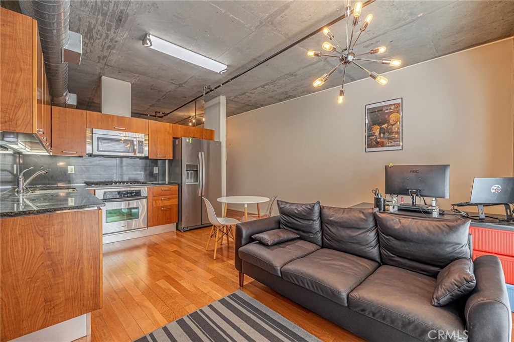 a living room with furniture and a chandelier
