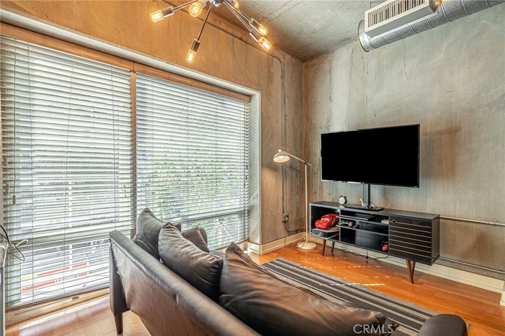 645 West 9th Street, Unit 301 Los Angeles, CA 90015 - Photo 4 of 14 a room with furniture and a flat screen tv