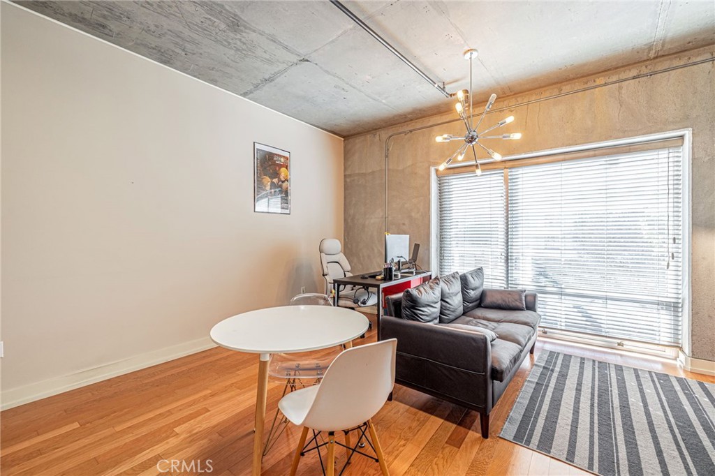 645 West 9th Street, Unit 301 Los Angeles, CA 90015 - Photo 5 of 14 a living room with furniture and a floor to ceiling window