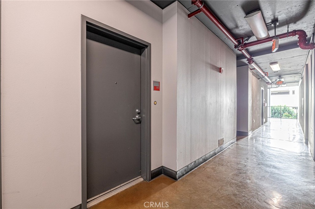 645 West 9th Street, Unit 301 Los Angeles, CA 90015 - Photo 10 of 14 a view of a hallway with wooden shelves