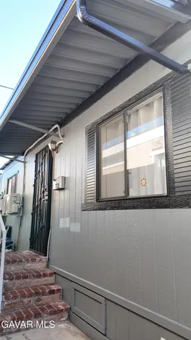a view of a dining room with furniture and a chandelier
