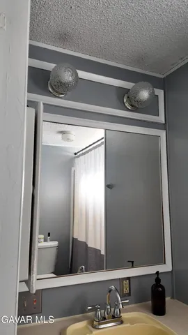 a white toilet sitting next to a bathroom sink and vanity