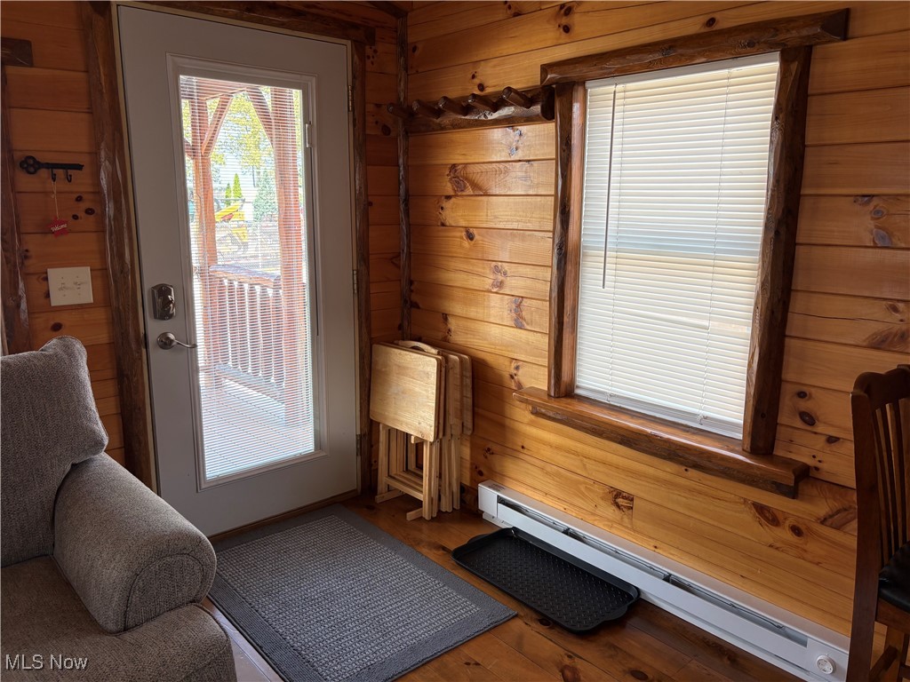 5919 Lake Road West, Unit 7 Ashtabula, OH 44004 - Photo 18 of 29 Entryway featuring a baseboard heating unit, wooden walls, and wood finished floors