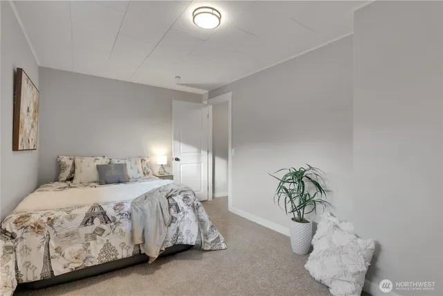 a bedroom with a bed and a potted plant