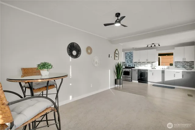 a view of a kitchen with furniture and wooden floor