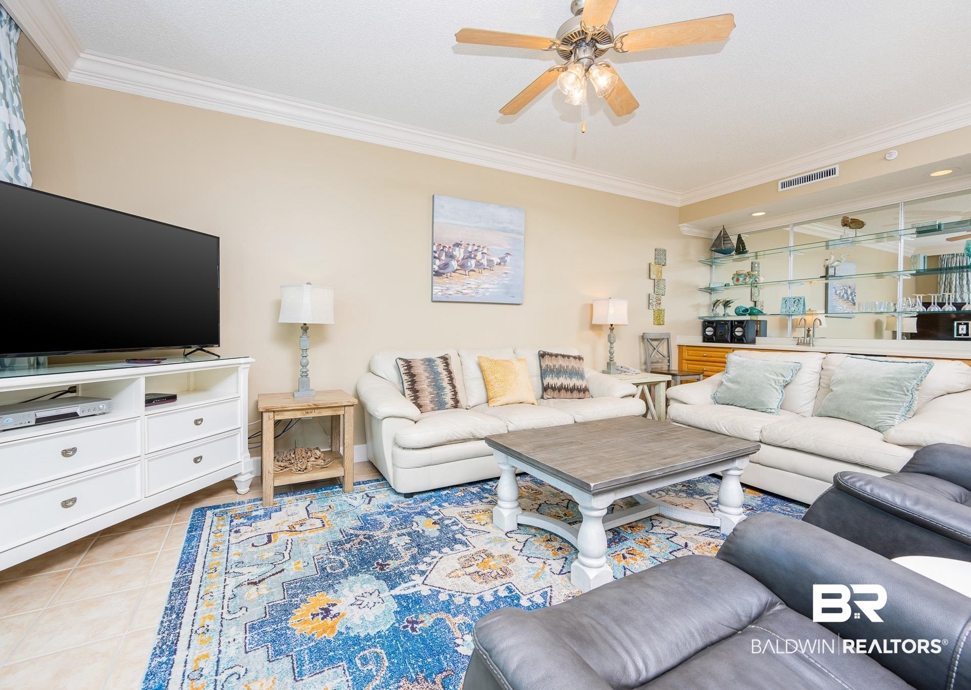 27580 Canal Road, Unit 1429 Orange Beach, AL 36561 - Photo 8 of 45 Living area featuring crown molding, light tile patterned floors, and a ceiling fan
