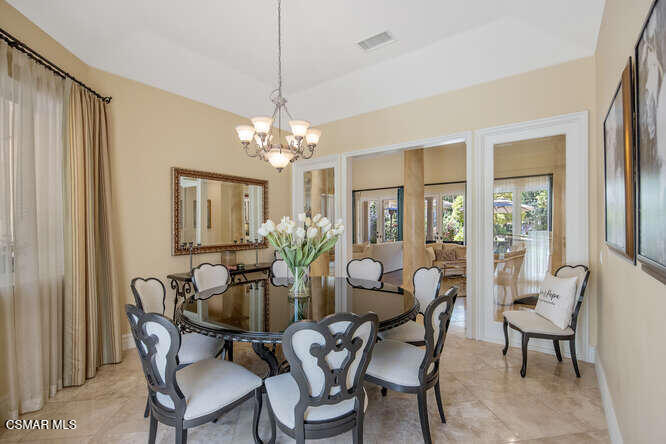 421 Whitegate Road Newbury Park, CA 91320 - Photo 11 of 76 a dining room with furniture a chandelier and wooden floor