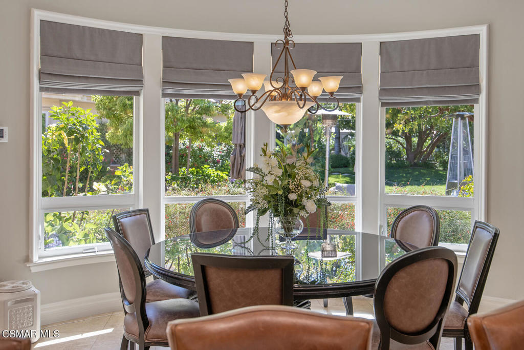 421 Whitegate Road Newbury Park, CA 91320 - Photo 19 of 76 a dining room with furniture a chandelier and wooden floor